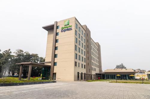 a building with a sign on the front of it at Holiday Inn Express Kolkata Airport by IHG in Kolkata