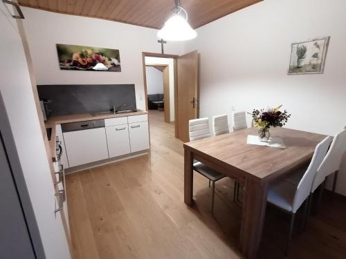 a kitchen and dining room with a wooden table and chairs at Ferienwohnung Stiegengraben in Göstling an der Ybbs