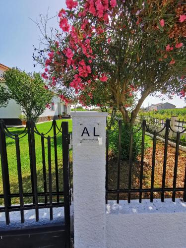 a black fence with a sign that says al on it at Casa das Portas in Azinhaga