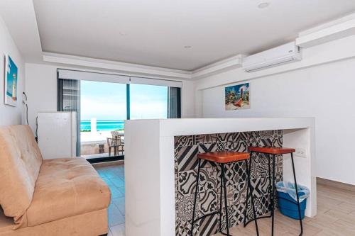 a living room with a couch and a table at Villas Marlin 108, a pie de playa, albercas, jacuzi, ubicacion inmejorable in Cancún