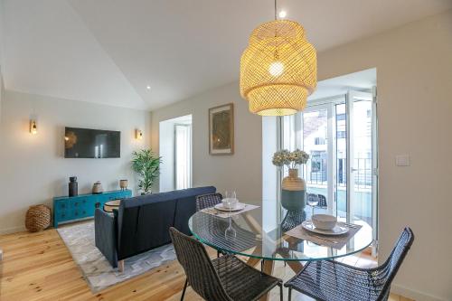 a dining room with a glass table and chairs at LovelyStay - Downtown Studio with Pool, AC and Balcony in Porto