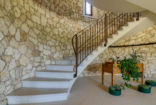 a stairway with a stone wall and stairs with plants at La Fonte degli Dei in Negrar