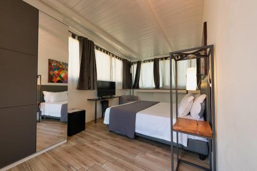 ローマにあるHotel Casa Miaのベッドとテレビが備わるホテルルームです。