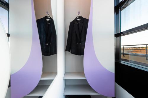 a room with surfboards on a wall next to a door at Prize by Radisson, Rostock City in Rostock
