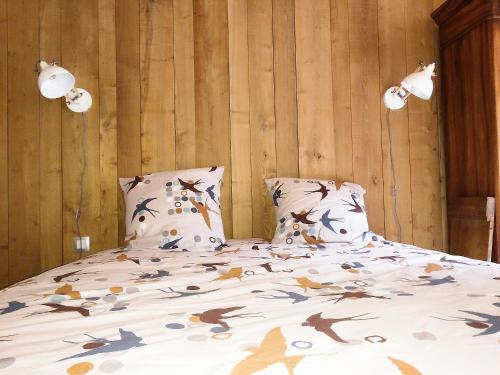 a bedroom with a large bed with two pillows at Les Billardes - le gite - Jura in Gizia