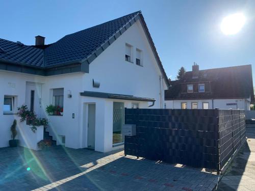 a white house with a black fence in front of it at Joanna Apartment - MA Casterfeld in Mannheim