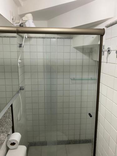 a bathroom with a glass shower with a toilet at Nannai Beira Mar, Flat Duplex em Muro Alto - Porto de Galinhas in Porto De Galinhas