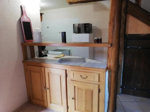 una pequeña cocina con encimera y microondas en le vieux chêne, en Parois