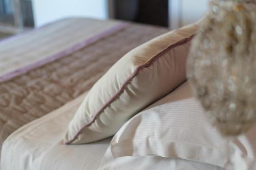 a close up of a bed with a pillow at DON GIULIO LUXURY ROOMS jacuzzi in Vico Equense