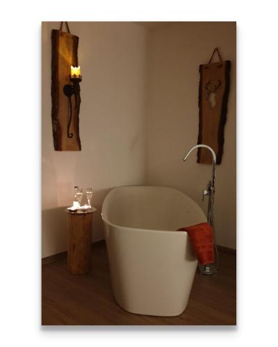 a bath tub in a bathroom with a sink at Harz Zeit in Altenau