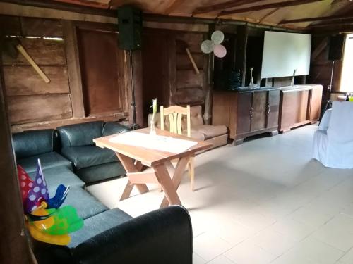 a living room with a table and a couch at Dom Gościnny Bogdany in Barczewo