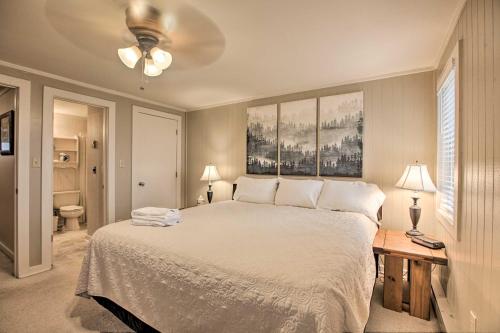 a bedroom with a large white bed and a bathroom at Slopeside Snowshoe Condo - Walk to Ski Lifts! in Dunmore