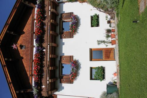 an overhead view of a building with flowers on it at Haus Oberland in Sankt Anton am Arlberg