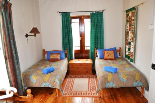 a bedroom with two beds and a window at Deer Cottage in Kirkwood