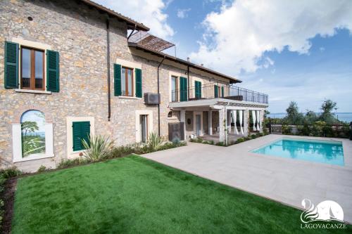 ein Haus mit Pool und Hof in der Unterkunft Luxus Gardoncino in Manerba del Garda