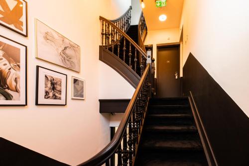 a staircase in a building with art on the walls at Boutique Hotel 43 in Koog aan de Zaan