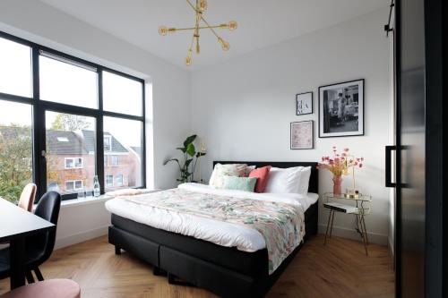 a bedroom with a large bed and a window at Boutique Hotel 43 in Koog aan de Zaan