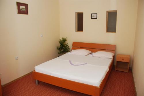 a bedroom with a large bed with white sheets at Apartments Ismy in Ulcinj