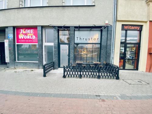 a store with benches in front of a building at Thruster - Rooms, Kitchen, Chill-Out Zone-Netflix, Lobby-Netflix in Gdynia
