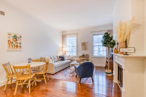 a living room with a couch and a table and chairs at The Goose Getaway in Savannah