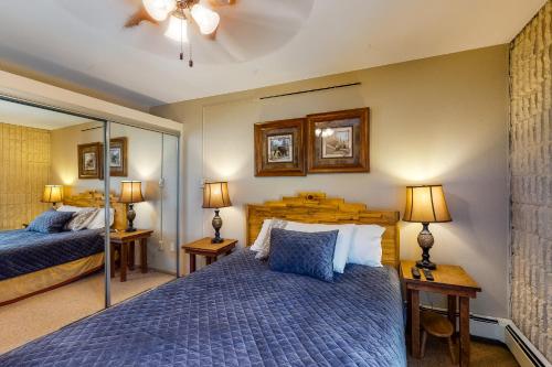 a bedroom with two beds and two lamps at Vail 21 in Vail