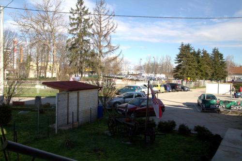 a parking lot with cars parked in a parking lot at Guest House Ivac Inn Zagreb Airport in Velika Gorica
