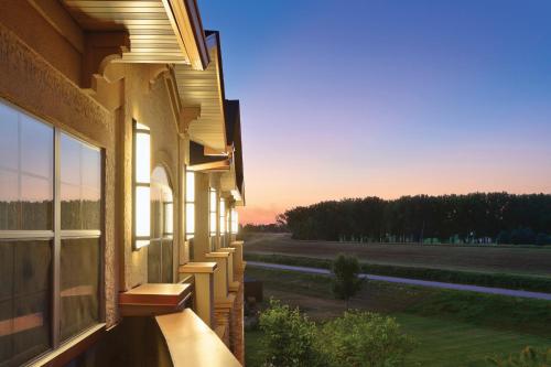 a building with a balcony with a view of a field at ClubHouse Hotel Sioux Falls in Sioux Falls
