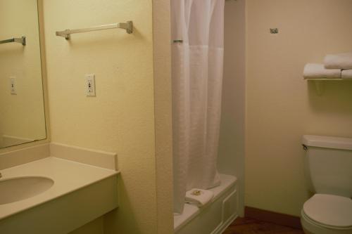 a bathroom with a sink and a toilet and a mirror at La Quinta Inn by Wyndham Austin Capitol / Downtown in Austin