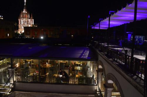a restaurant with purple lights in a city at night at Casa 1810 Hotel Boutique in San Miguel de Allende