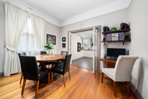 a dining room with a table and chairs at Bakers Retreat in Hobart