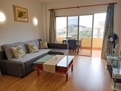 a living room with a couch and a coffee table at Sea view 1B Los Cristianos in El Guincho