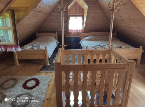 a bedroom with two beds in a attic at Suncevica Apartmani in Arilje