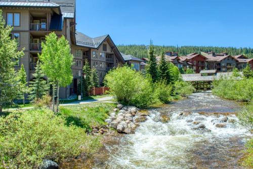 a river in front of a lodge at Peregrine in Copper Mountain