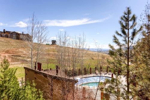 a house on a hill with a swimming pool at Christie Club in Steamboat Springs