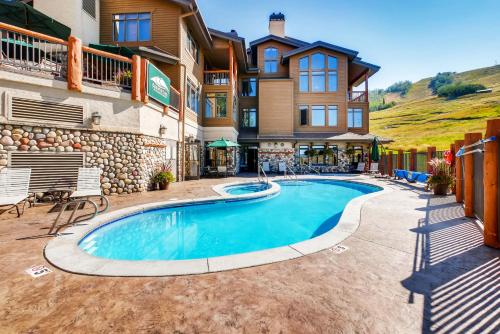 a resort style pool in front of a building at Christie Club in Steamboat Springs