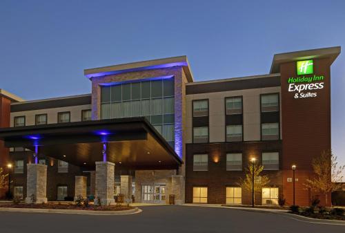 a building with a sign that reads embassy express and suites at Holiday Inn Express & Suites - Milwaukee - Brookfield by IHG in Brookfield