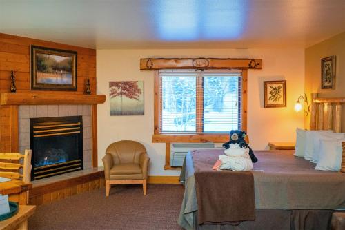 a bedroom with a teddy bear sitting on a bed at Spearfish Canyon Lodge in Spearfish