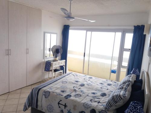 a bedroom with a bed and a window at 197 Stella Maris in Amanzimtoti