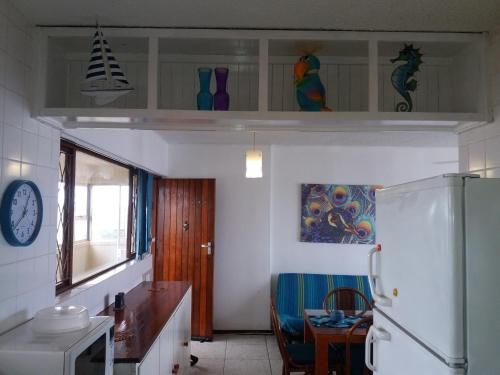 a kitchen with a refrigerator and a table in it at 197 Stella Maris in Amanzimtoti