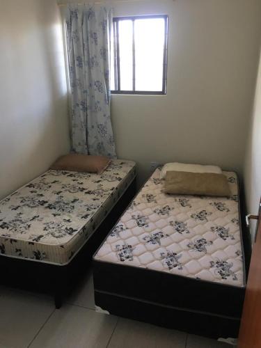 two beds sitting next to each other in a room at Sereia de Carapibus in Jacumã
