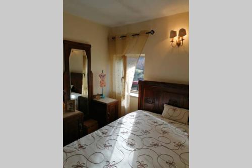 a bedroom with a bed and a large mirror at Casa do Palheiro in Montalegre