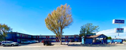 a tree in a parking lot in front of a building at Budget Inn in Roswell