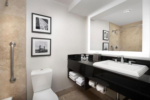 a bathroom with a toilet, sink, and bathtub at Crowne Plaza Hotel Portland-Downtown Convention Center, an IHG Hotel in Portland