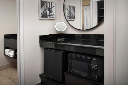 a bathroom with a microwave and a mirror on the wall at Crowne Plaza Hotel Portland-Downtown Convention Center by IHG in Portland