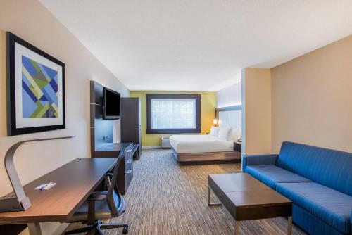 a hotel room with a couch and a bed at Holiday Inn Express Hotel & Suites Atascadero by IHG in Atascadero