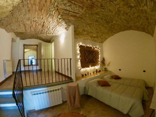 a bedroom with two beds and a stone wall at Papiriana la casa del borgo_ breathtaking sea wiew in Fosdinovo
