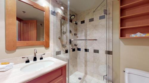a bathroom with a sink and a shower at Elegant Ski In Ski Out Condo by Harmony Whistler in Whistler