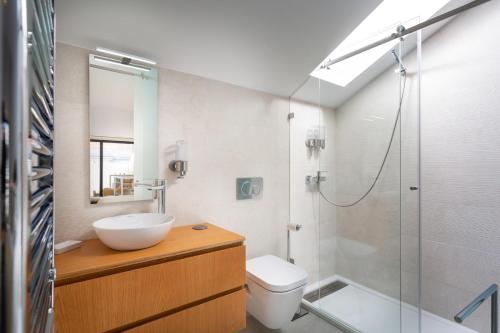 a bathroom with a sink and a toilet and a shower at STUPENDO-Three Rooms-Suite with Terrace -Center -Air conditioning in Lisbon