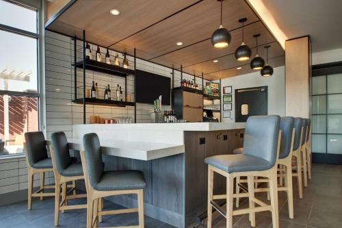 a bar with blue bar stools in a restaurant at Hyatt House Oak Brook in Oak Brook