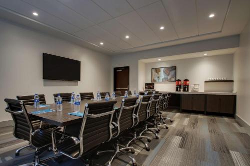 a conference room with a long table and chairs at Hyatt House Oak Brook in Oak Brook